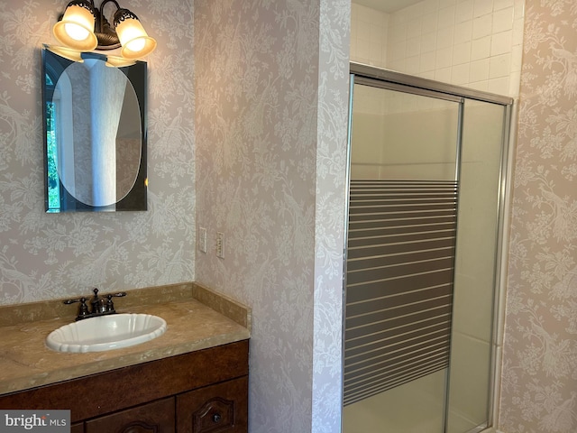 bathroom with vanity and a shower with shower door