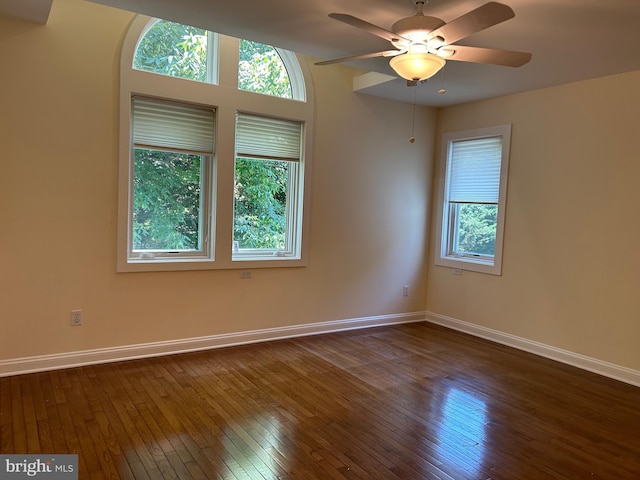 unfurnished room featuring ceiling fan and dark hardwood / wood-style floors