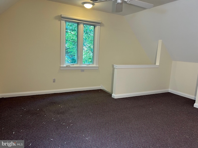 bonus room featuring dark carpet, vaulted ceiling, and ceiling fan