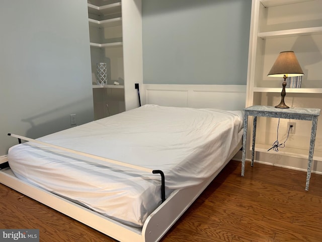 bedroom featuring dark hardwood / wood-style flooring