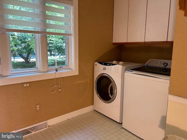 washroom with cabinets and independent washer and dryer