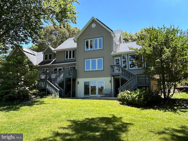 rear view of property featuring a yard and a wooden deck