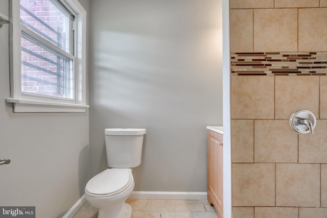 bathroom with tile patterned flooring, vanity, and toilet