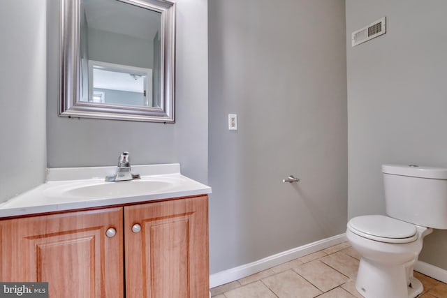 bathroom with tile patterned floors, vanity, and toilet