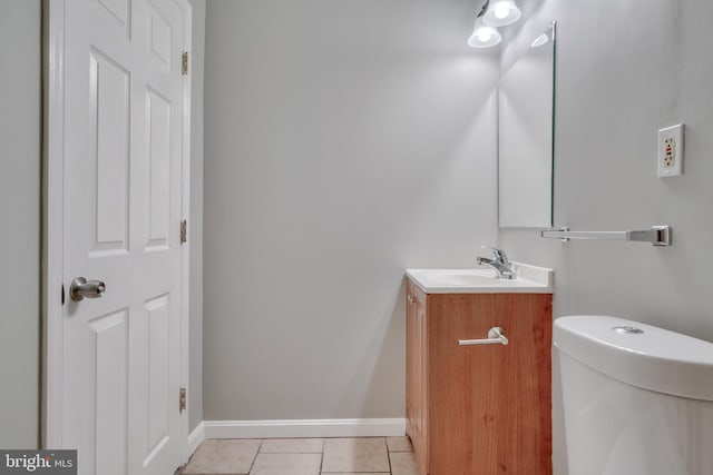 bathroom featuring toilet, vanity, and tile patterned floors