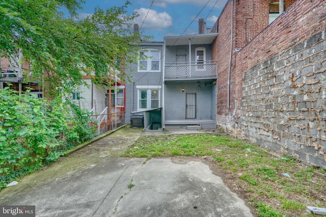 back of property featuring a balcony