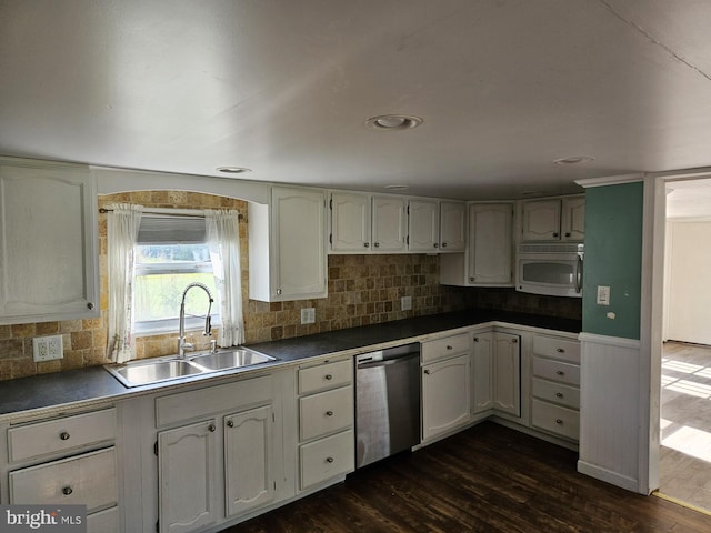 kitchen with sink, white cabinetry, dishwasher, and dark hardwood / wood-style flooring