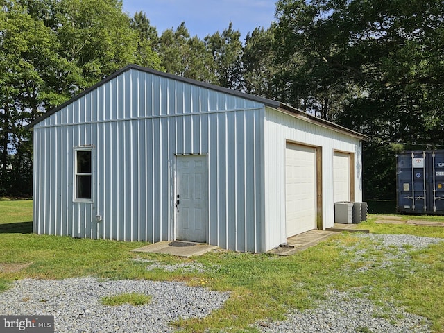 view of outbuilding with a garage and a yard