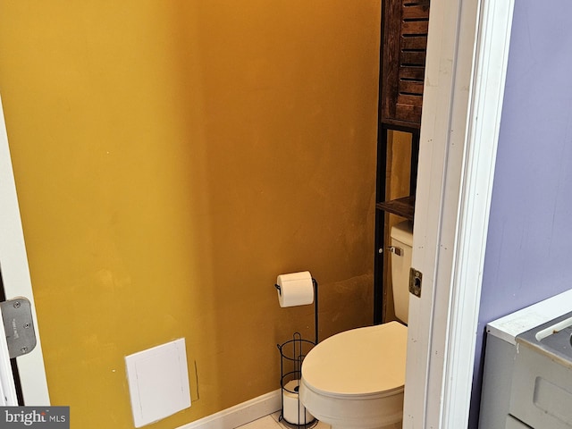 bathroom with toilet and tile patterned floors