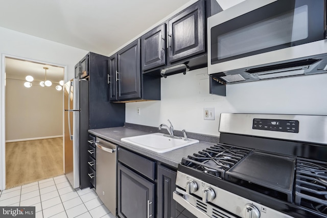 kitchen featuring sink, light tile patterned floors, and stainless steel appliances