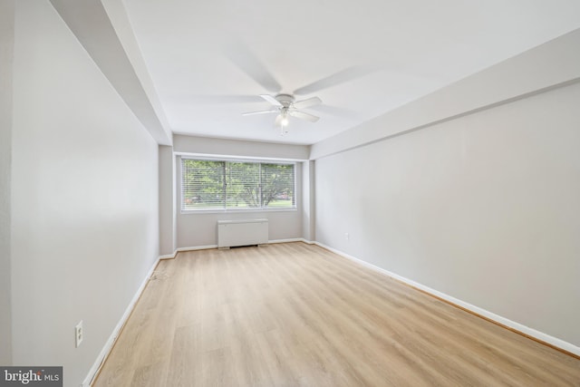 unfurnished room featuring light wood-type flooring and ceiling fan