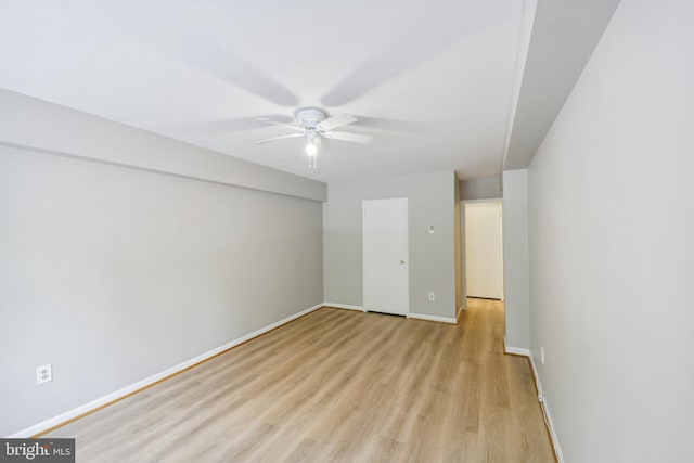 empty room with ceiling fan and light hardwood / wood-style floors