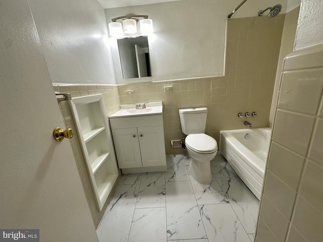 full bathroom with vanity, tile walls, tiled shower / bath, toilet, and tile patterned flooring