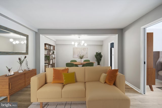 living room with a notable chandelier, a wealth of natural light, and hardwood / wood-style floors