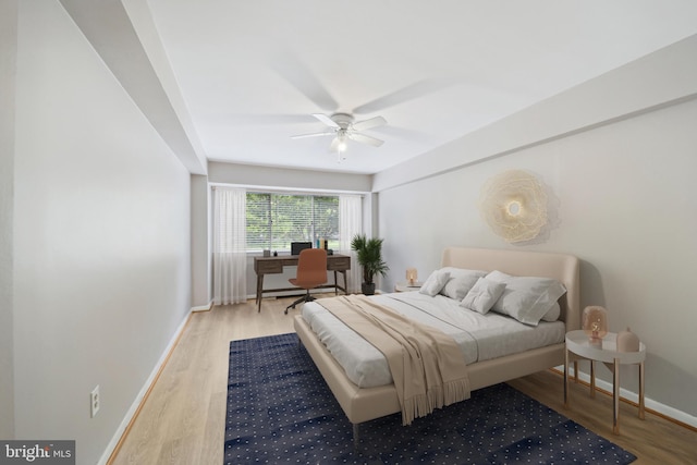 bedroom with wood-type flooring and ceiling fan