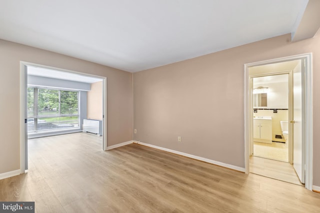 spare room featuring light hardwood / wood-style floors