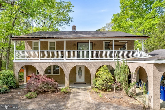 view of front of house featuring a balcony