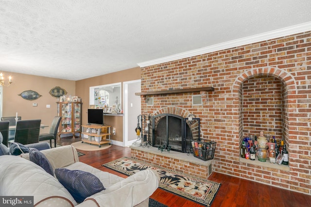 living room featuring a textured ceiling, dark hardwood / wood-style flooring, and a fireplace