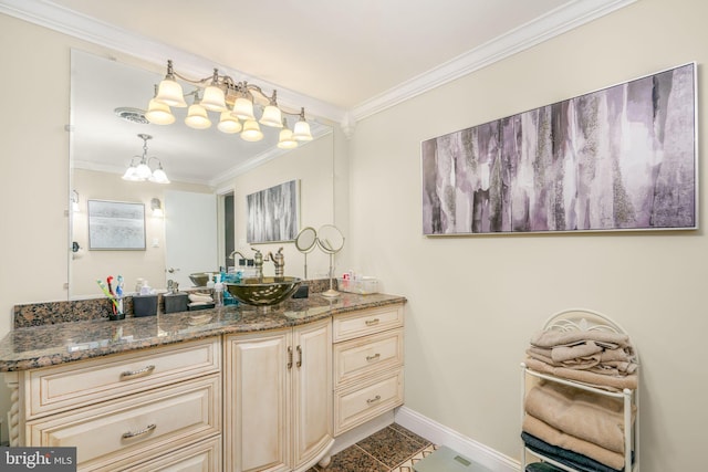 bathroom featuring crown molding, vanity, and a notable chandelier