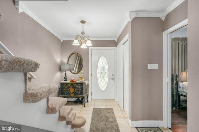 tiled entryway with a chandelier and crown molding