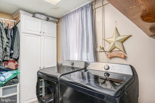 washroom featuring cabinets and independent washer and dryer