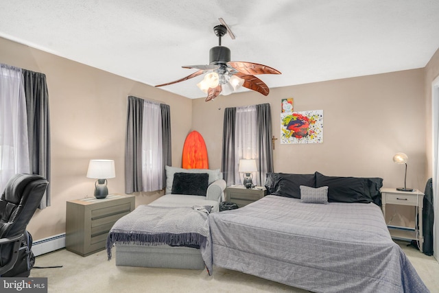 bedroom featuring baseboard heating, ceiling fan, and light colored carpet