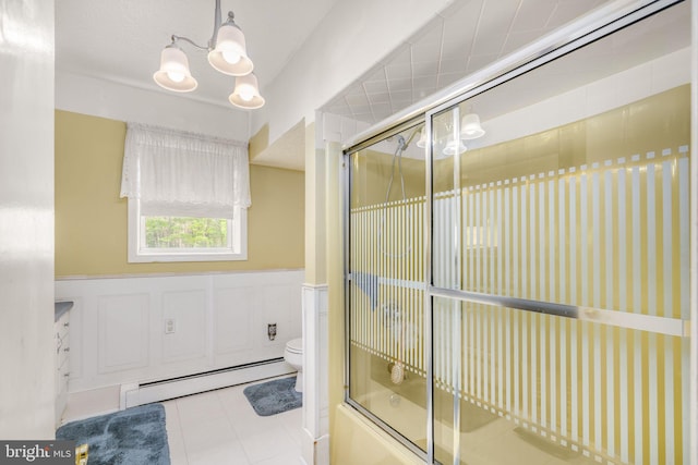 bathroom with shower / bath combination with glass door, a baseboard radiator, and toilet