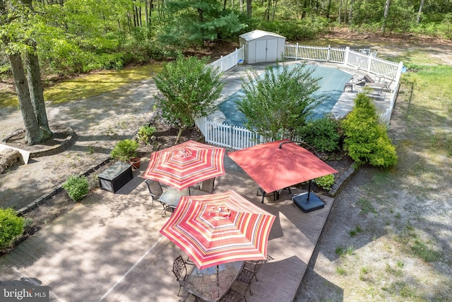 view of patio / terrace featuring a shed and a covered pool