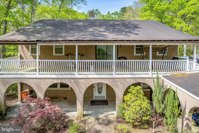 back of house featuring a balcony