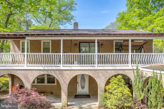 view of front of house featuring a balcony