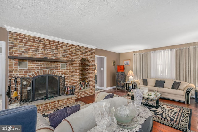 living room featuring a textured ceiling, hardwood / wood-style flooring, a brick fireplace, and crown molding