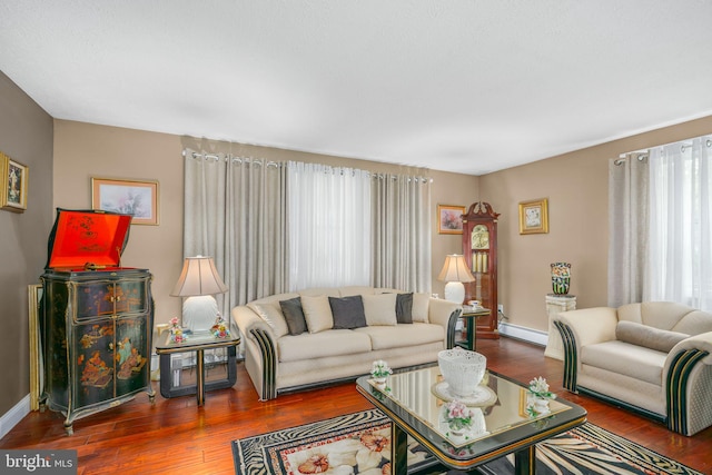 living room with hardwood / wood-style floors and baseboard heating