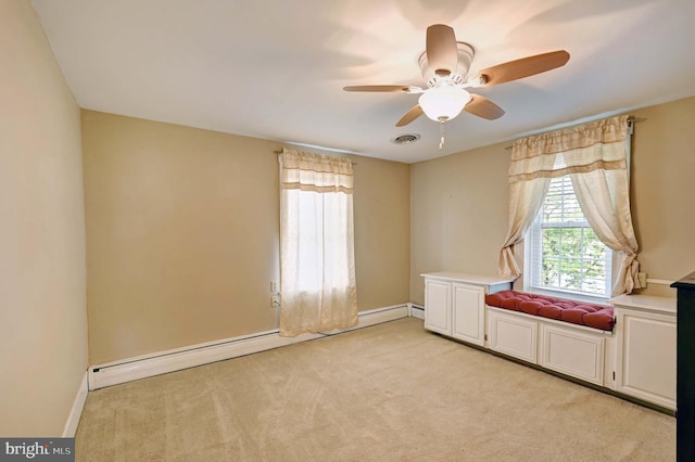 carpeted empty room featuring baseboard heating and ceiling fan