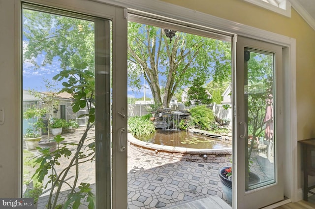 doorway to outside with ornamental molding