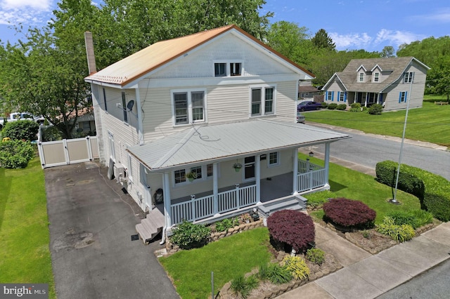 farmhouse with a front yard and a porch