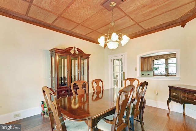 dining room featuring a chandelier, hardwood / wood-style flooring, and wood ceiling