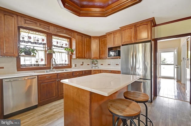 kitchen with stainless steel appliances, light hardwood / wood-style flooring, and backsplash