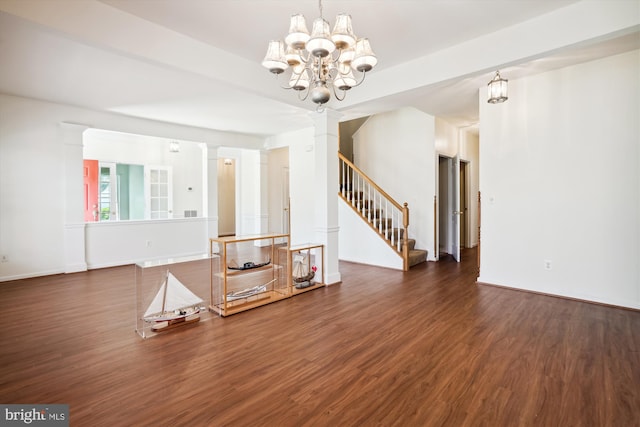 unfurnished living room featuring dark hardwood / wood-style flooring and a notable chandelier