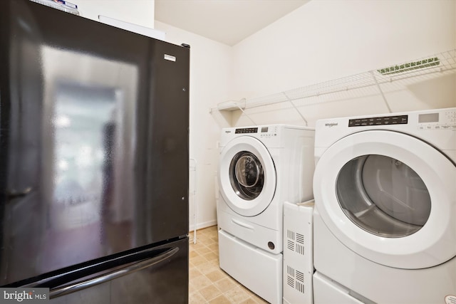 laundry room featuring washing machine and clothes dryer