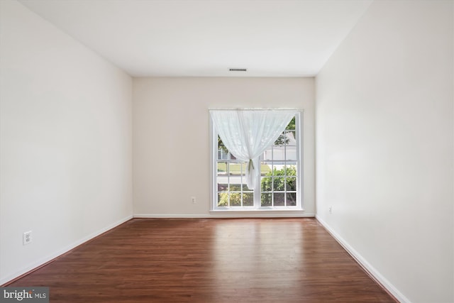 unfurnished room with wood-type flooring