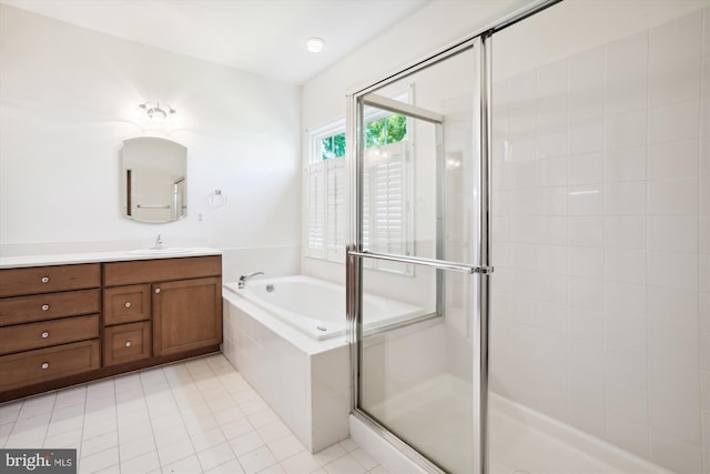 bathroom featuring tile patterned floors, vanity, and shower with separate bathtub