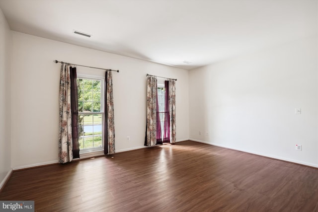 spare room featuring dark hardwood / wood-style floors