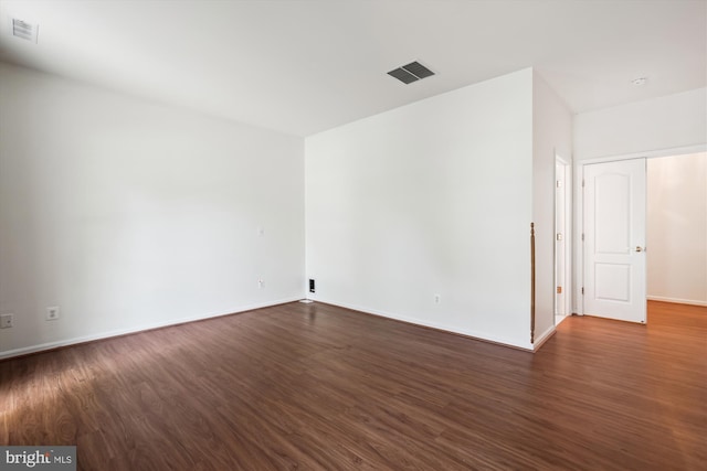 unfurnished room with dark hardwood / wood-style flooring