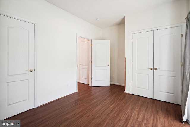 unfurnished bedroom featuring dark wood-type flooring