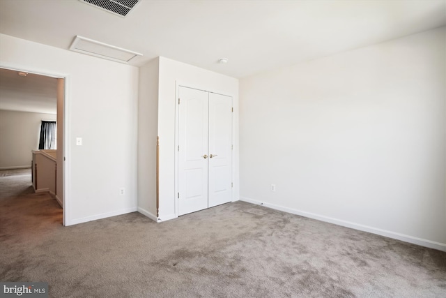 unfurnished bedroom with a closet and carpet