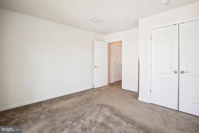 unfurnished bedroom with a closet and light colored carpet