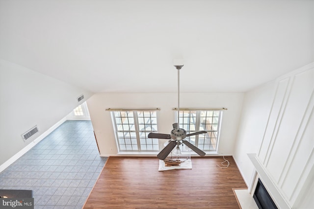 interior space featuring lofted ceiling, ceiling fan, and dark wood-type flooring