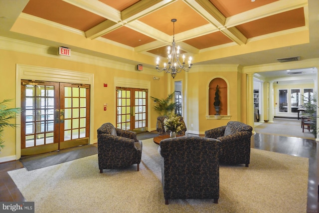 living room with coffered ceiling, an inviting chandelier, french doors, ornamental molding, and beamed ceiling