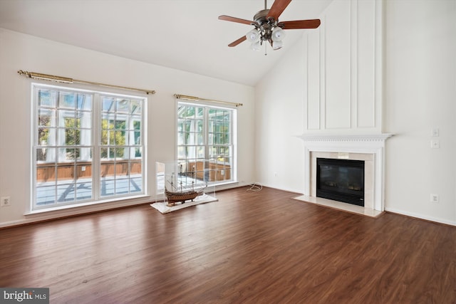 unfurnished living room featuring dark hardwood / wood-style floors, ceiling fan, a fireplace, and high vaulted ceiling