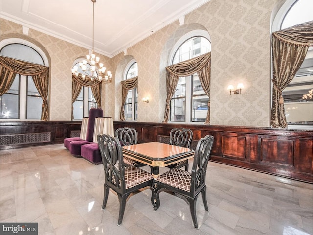 dining space featuring crown molding and a notable chandelier